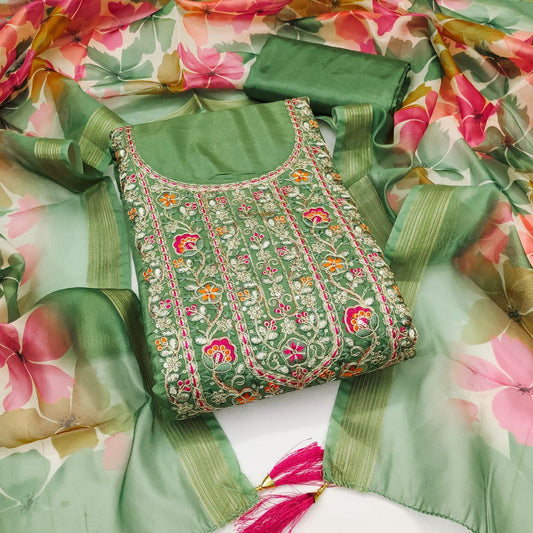 Green embroidered blouse with floral patterns on a floral fabric background