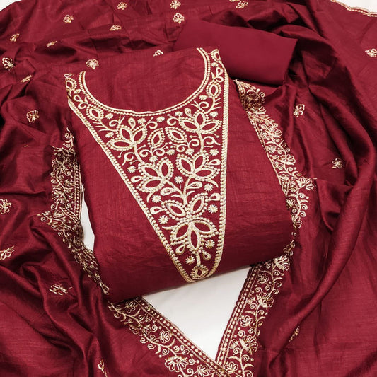 Red fabric with gold embroidery on a white background