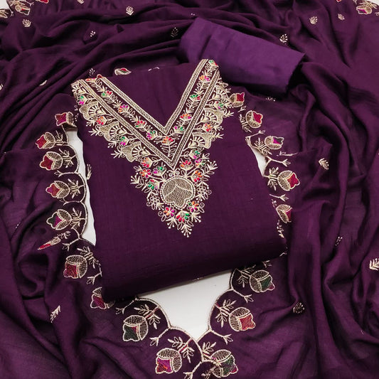 Purple fabric with intricate gold and multicolored embroidery on a white background
